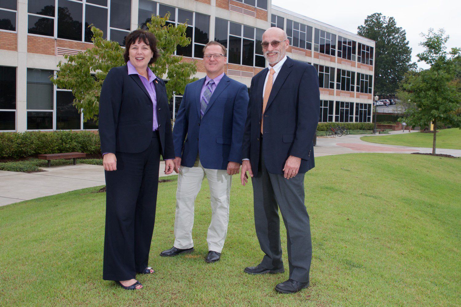 From left, College of Science Dean Cynthia Young stands outside Martin Hall alongside professor Kevin James and Christoph Cox, the newly named acting director of the School of Mathematical and Statistical Sciences.