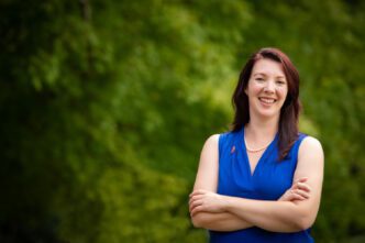 Mary Erin Morrissey stands outside and poses for a photo