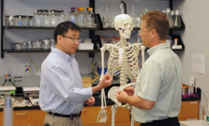 Hai Yao, the Ernest R. Norville Endowed Chair of bioengineering at Clemson University and leader of SC-TRIMH, talks with a student in his lab at MUSC.
