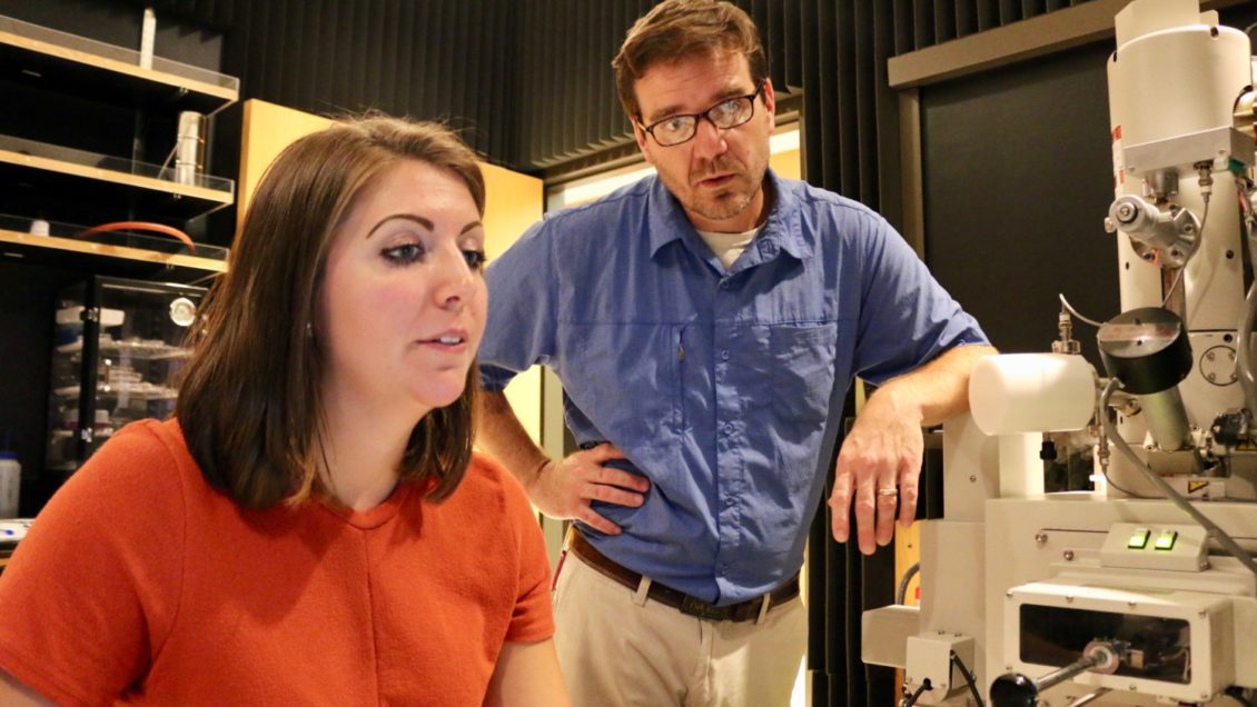 PhD student Kathryn Peruski works at the Electron Microscope Facility with Brian Powell, Fjeld professor in nuclear environmental engineering and science.