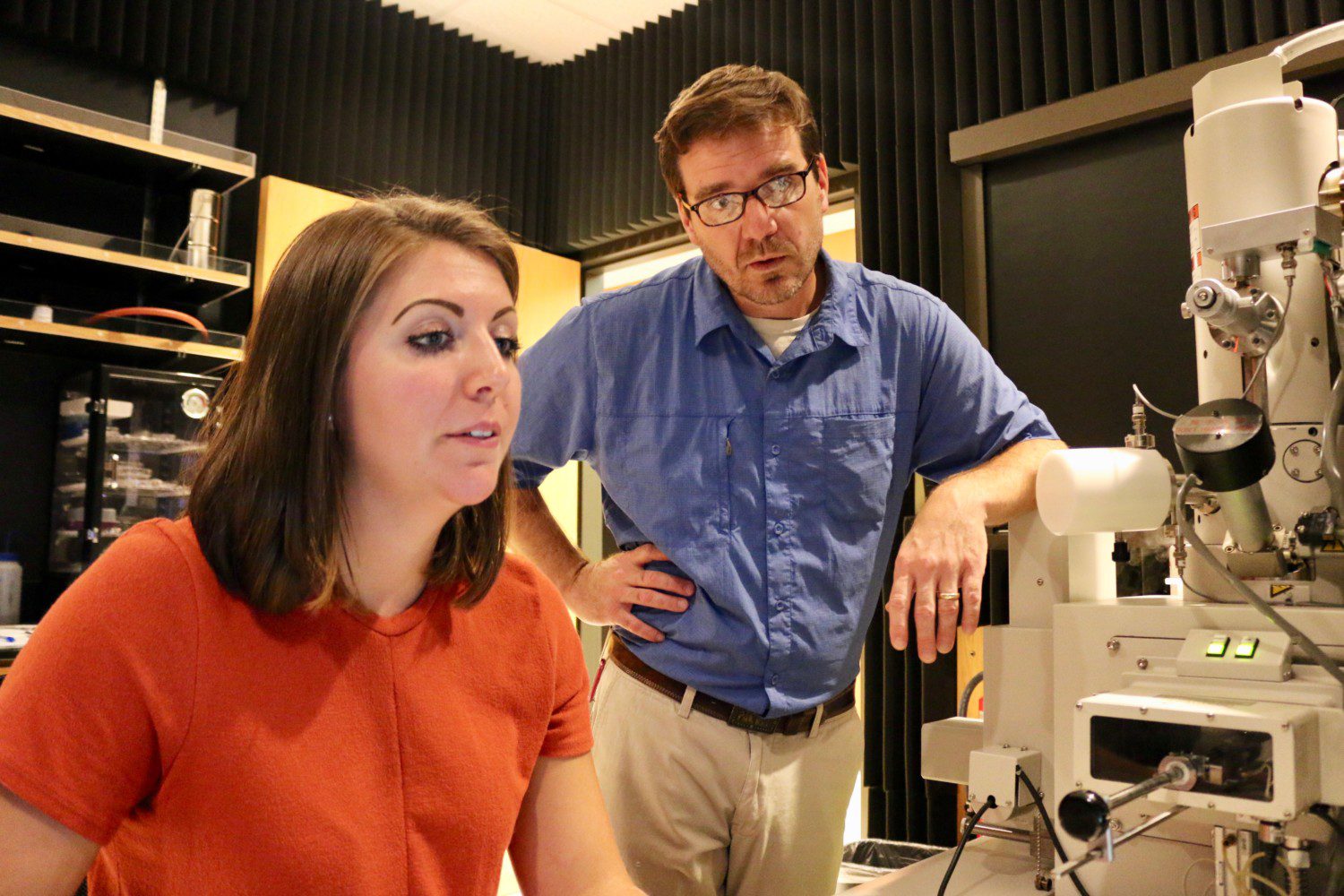 PhD student Kathryn Peruski works at the Electron Microscope Facility with Brian Powell, Fjeld professor in nuclear environmental engineering and science.