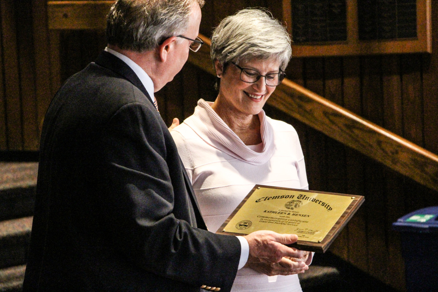 Kathy Hensen, administrative coordinator for the Office of the Vice President for Student Affairs for 14 years, was honored during a retirement reception Monday, Oct. 29. Here, she accepts a plaque commemorating her service from Associate Vice President and Chief of Staff for Student Affairs, George Smith.