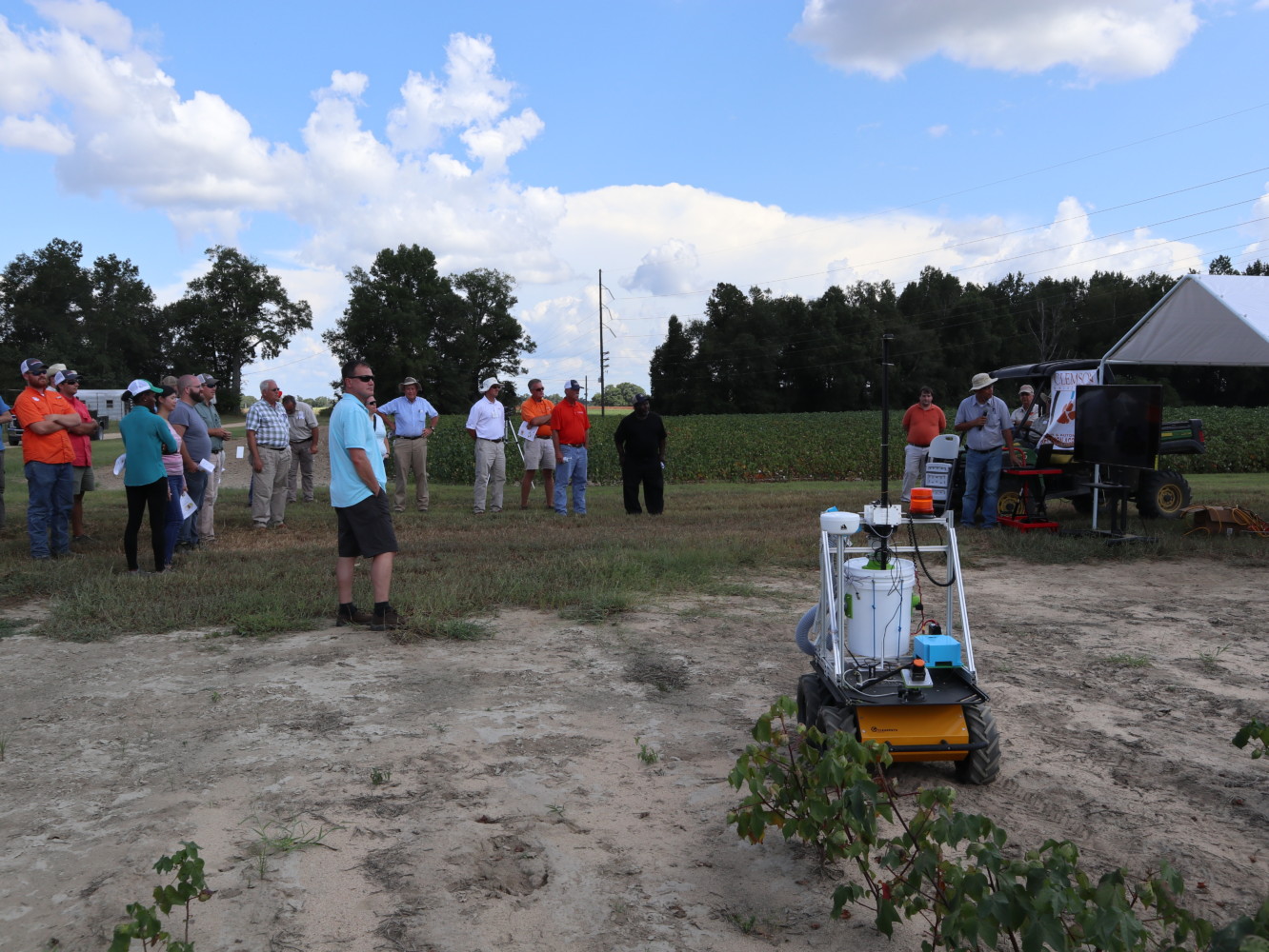 Participants at the 2018 Edisto Research and Education Field Day listen with interest at researcher Joe Mari Maja talks about a UGV cotton harvester he is working to develop.