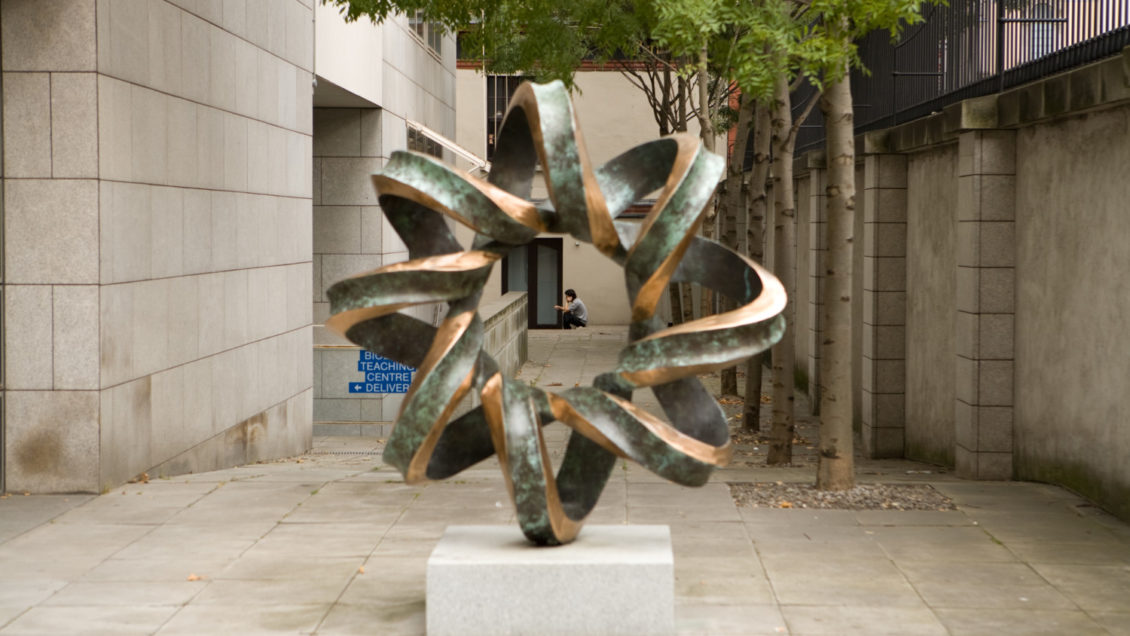 The sculpture of "The Double Helix" by Brian King stands outside the Smurfit Institute of Genetics at Trinity College Dublin.