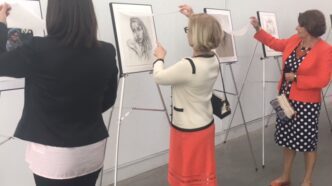Patrons viewing the Portrayed exhibition