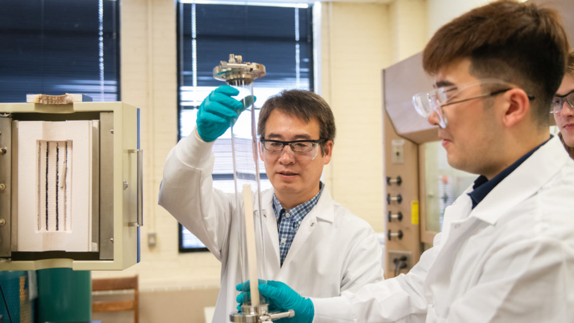 Jianhua “Joshua” Tong, left, and Ph.D. student Shenlong Mu work in their Sirrine Hall lab, where they are working on new technology that combines 3D printing and laser processing.