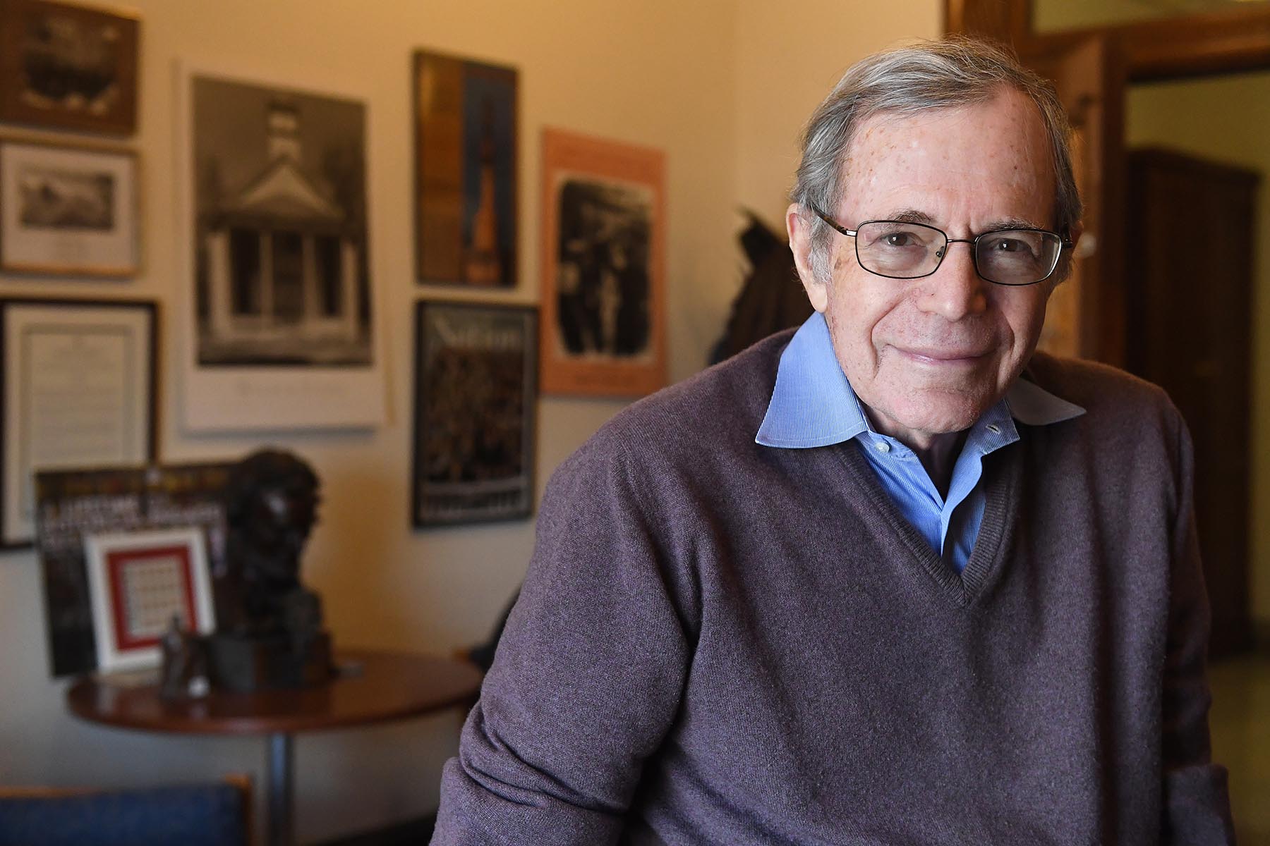 Image of Eric Foner in office in front of historic images