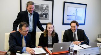 MBA director Greg Pickett joins cohorts as they prepare for a negotiation session