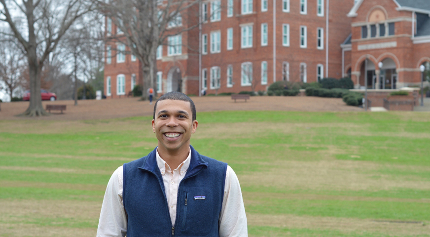 Chris Norman, standing in front of Tillman, is a first-generation graduate