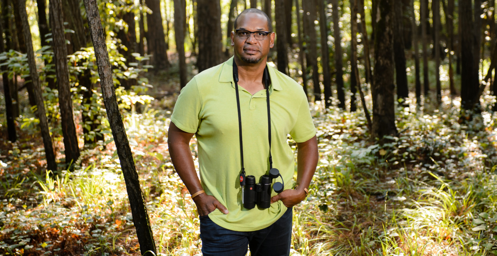 J. Drew Lanham with binoculars in the woods.