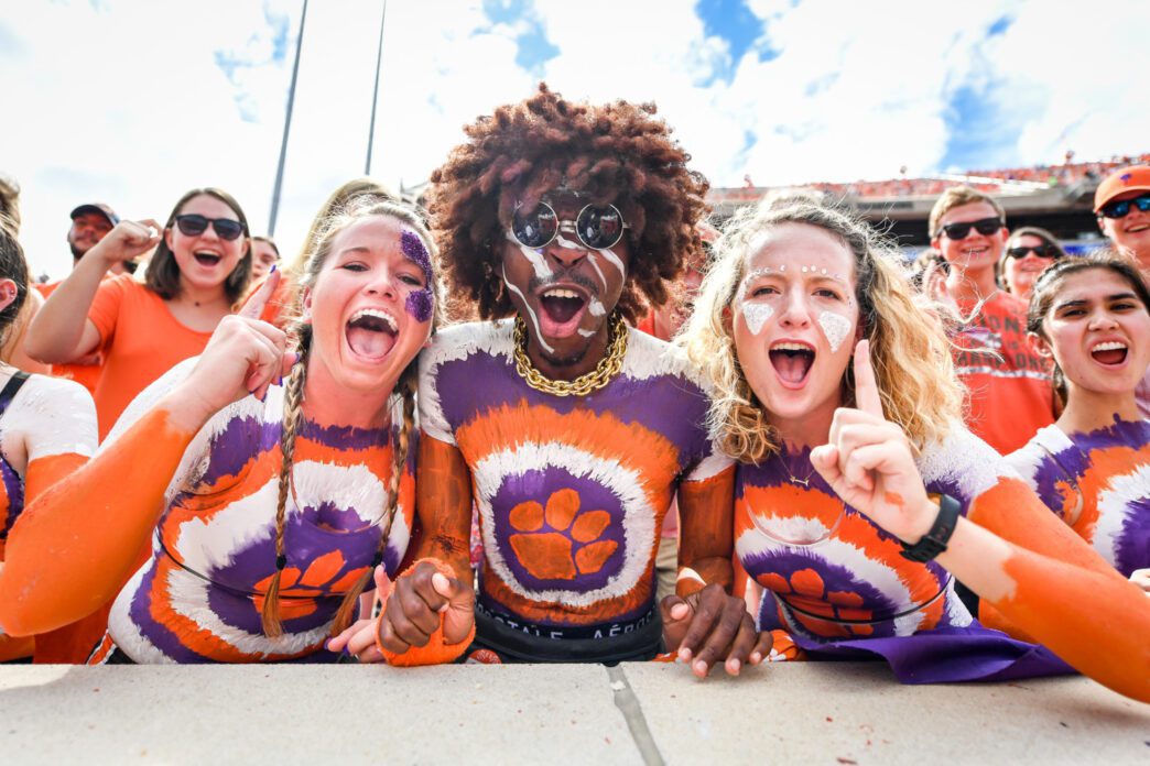 Members of Central Spirit, complete with full-body paint, cheer at a 2018 home football game for the Tigers.