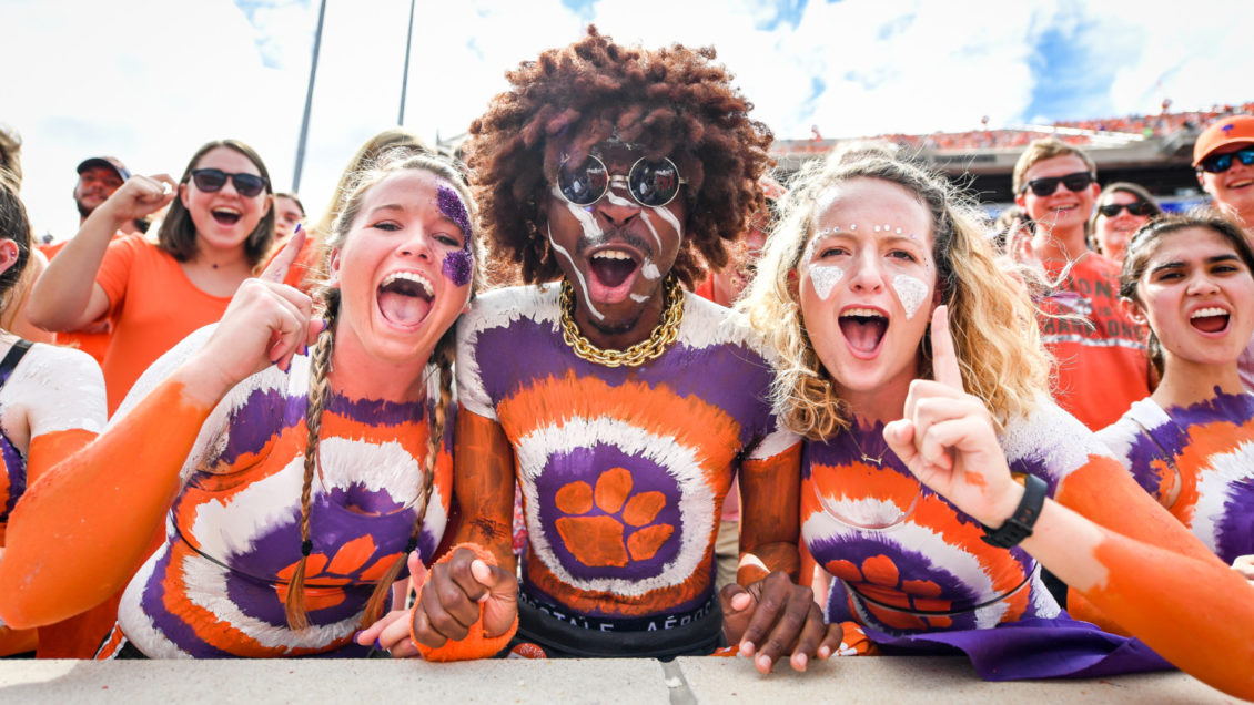 Members of Central Spirit, complete with full-body paint, cheer at a 2018 home football game for the Tigers.