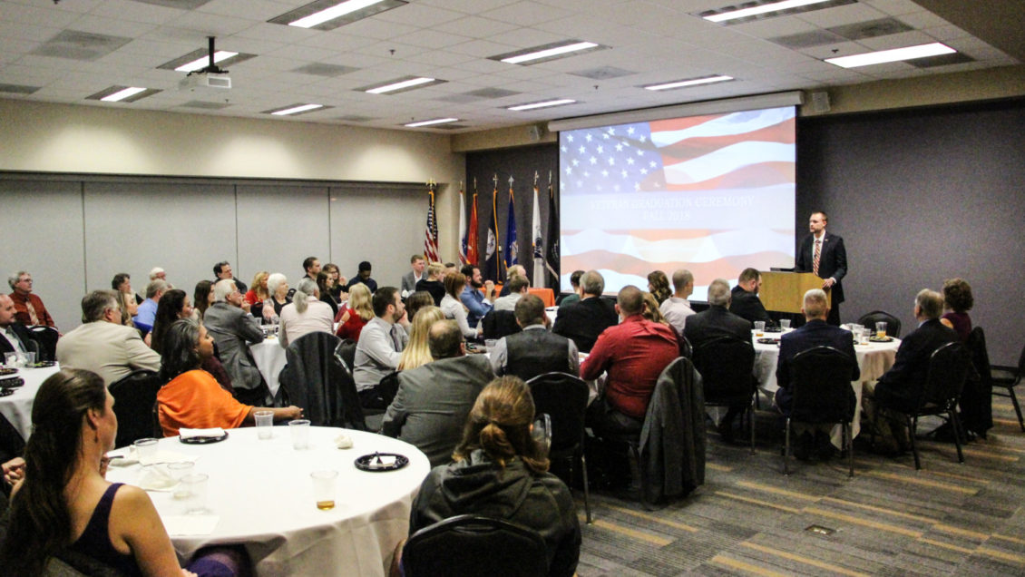 Brennan Beck speaks in front of graduating student veterans, families and special guests at the fall 2018 "Hail and Farewell" recognition inside Hendrix Student Center.