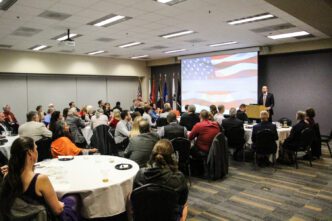 Brennan Beck speaks in front of graduating student veterans, families and special guests at the fall 2018 "Hail and Farewell" recognition inside Hendrix Student Center.