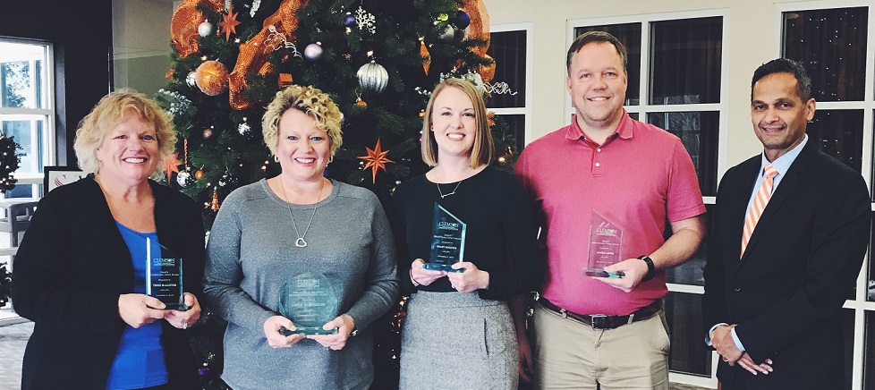 Staff award winners were (from left) Teresa McAllister, Leigh Humphries, Kaley Goodwin, and James Lowe. They posed for a photo with Anand Gramopadhye, dean of the College of Engineering, Computing and Applied Sciences.