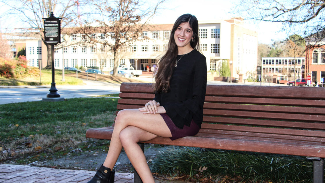 December 2018 graduate Madeline Cordell in front of the Trustee House for a photo shoot.