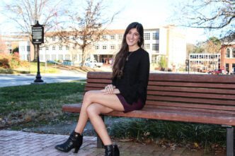 December 2018 graduate Madeline Cordell in front of the Trustee House for a photo shoot.