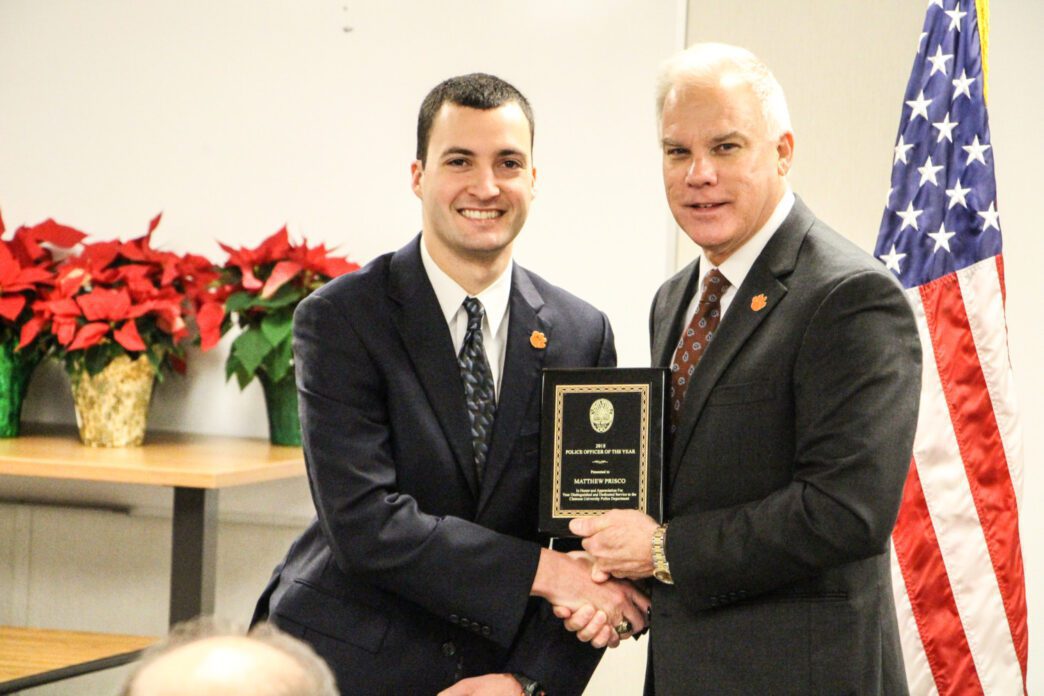Matthew Prisco, 2018 Clemson University Police Officer of the Year, receiving his plaque from Associate Vice President for Public Safety and Chief of Police Greg Mullen.