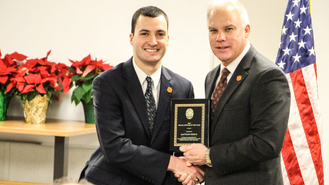 Matthew Prisco, 2018 Clemson University Police Officer of the Year, receiving his plaque from Associate Vice President for Public Safety and Chief of Police Greg Mullen.