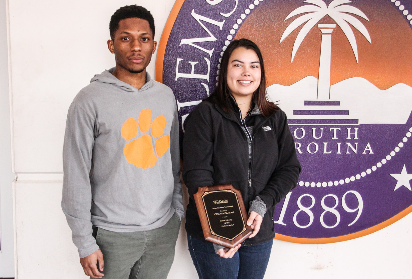 Ty Robinson and Victoria Graham, VA work-study students at Clemson, in front of the university seal at Vickery Hall.