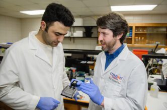 Will Richardson, left, speaks with Ph.D. student Amirreza Yeganegi in their Clemson University lab.