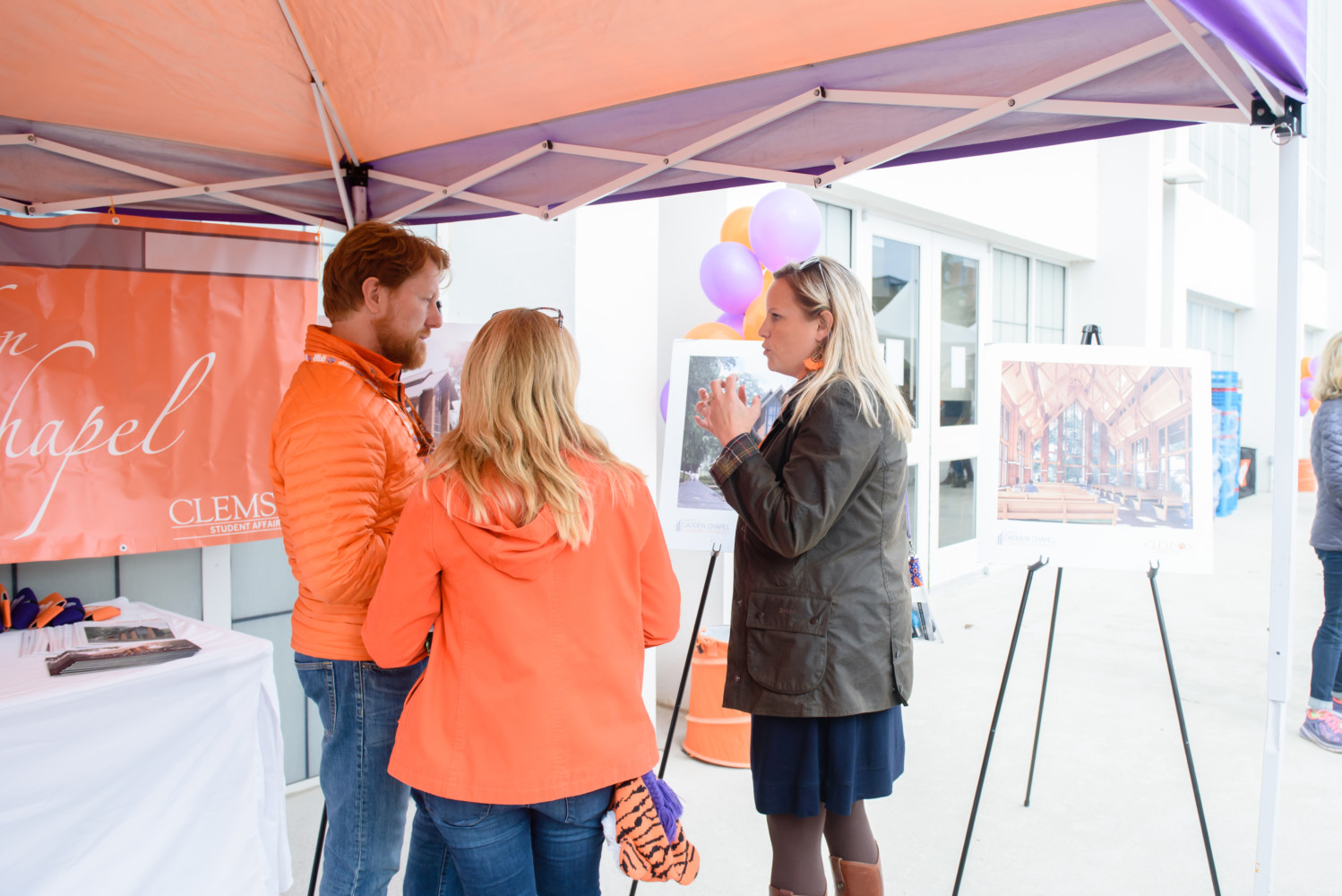 Brandy Page (right) discusses the Samuel J. Cadden Chapel with prospective donors at a 2018 tailgate prior to a Clemson football game.