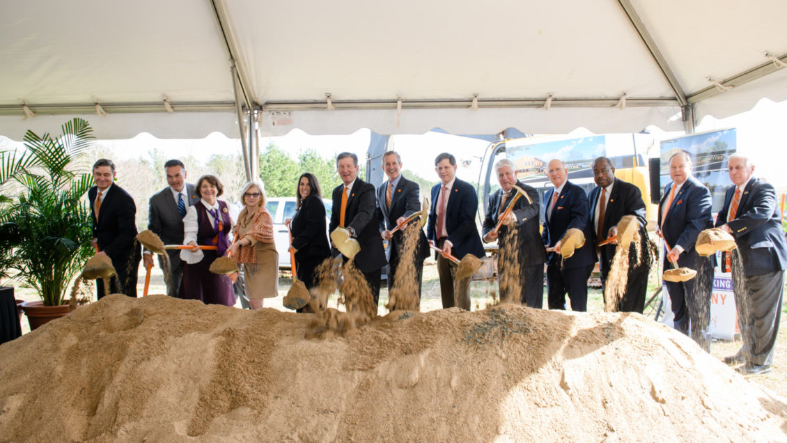 Clemson University trustees lift ceremonial shovelfuls of dirt at the groundbreaking for the Child Development Center.