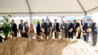 Clemson University trustees lift ceremonial shovelfuls of dirt at the groundbreaking for the Child Development Center.