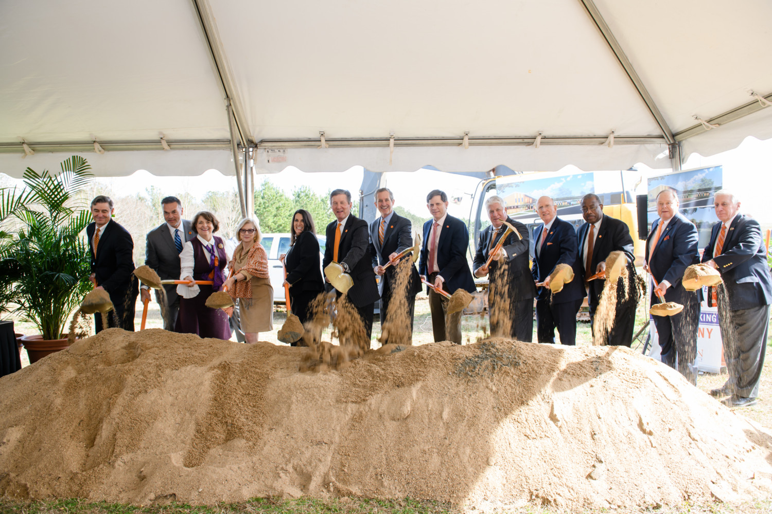 Clemson University trustees lift ceremonial shovelfuls of dirt at the groundbreaking for the Child Development Center.