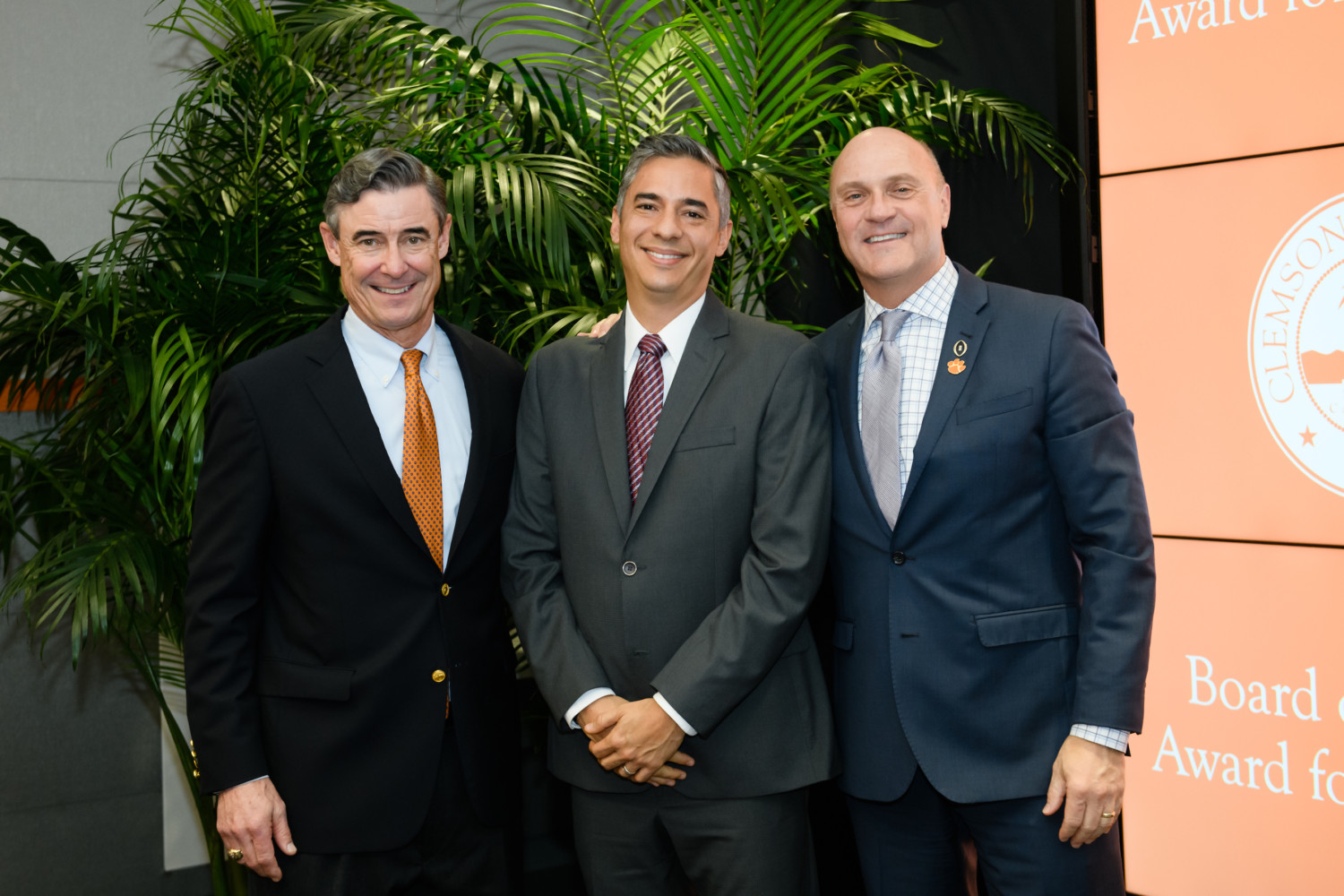 Hugo Sanabria (center) was joined by Board of Trustees chair Smyth McKissick and President Jim Clements as Sanabria received the Board of Trustees’ Award for Excellence.