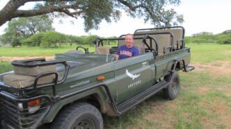 Laura Gigliotti sits in a safari truck in South Africa.