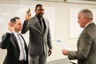 Lieutenants Mark Gregory and Michael Collins are sworn in officially by Chief of Police Greg Mullen during a monthly staff meeting.