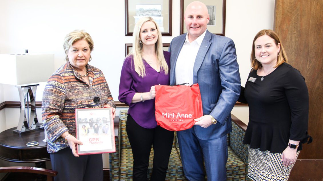Almeda Jacks meets with donors of CPR training kits provided by the American Heart Association.