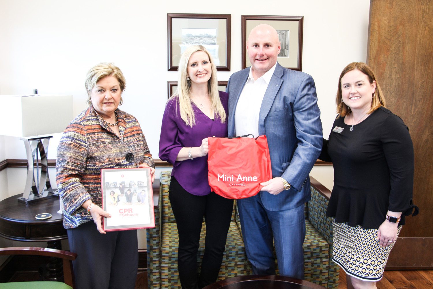 Almeda Jacks meets with donors of CPR training kits provided by the American Heart Association.