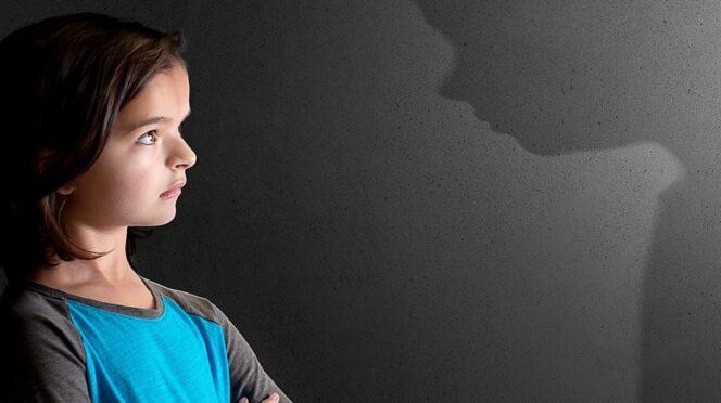 A young girl stands to the left with her arms crossed. To the right, a shadow is seen staring down at her menacingly.