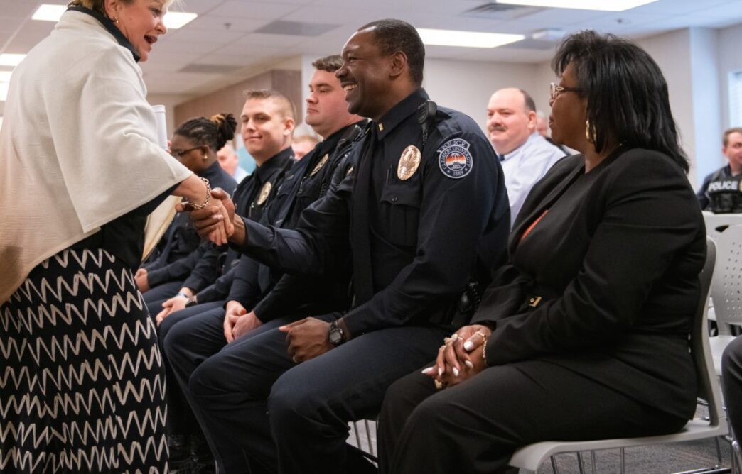 Michael Collins shakes hands with Vice President for Student Affairs Almeda Jacks.