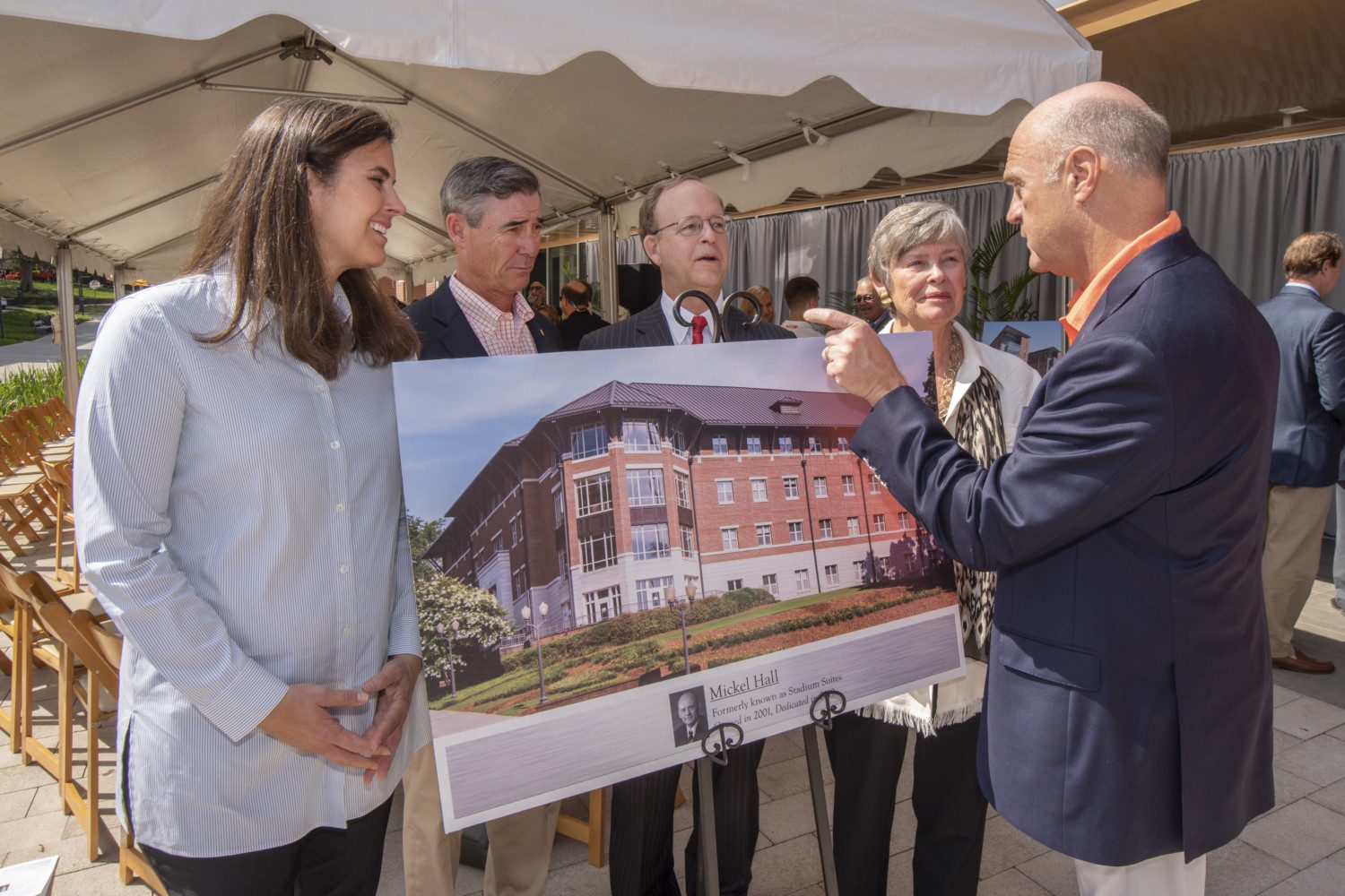 President Jim Clements and Board of Trustees Chairman Smyth McKissick visit with the Mickel family after Saturday's residence hall naming ceremony.