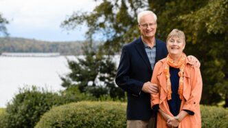 Clemson donors John and Laurie Gutshaw stand in front of Lake Hartwell
