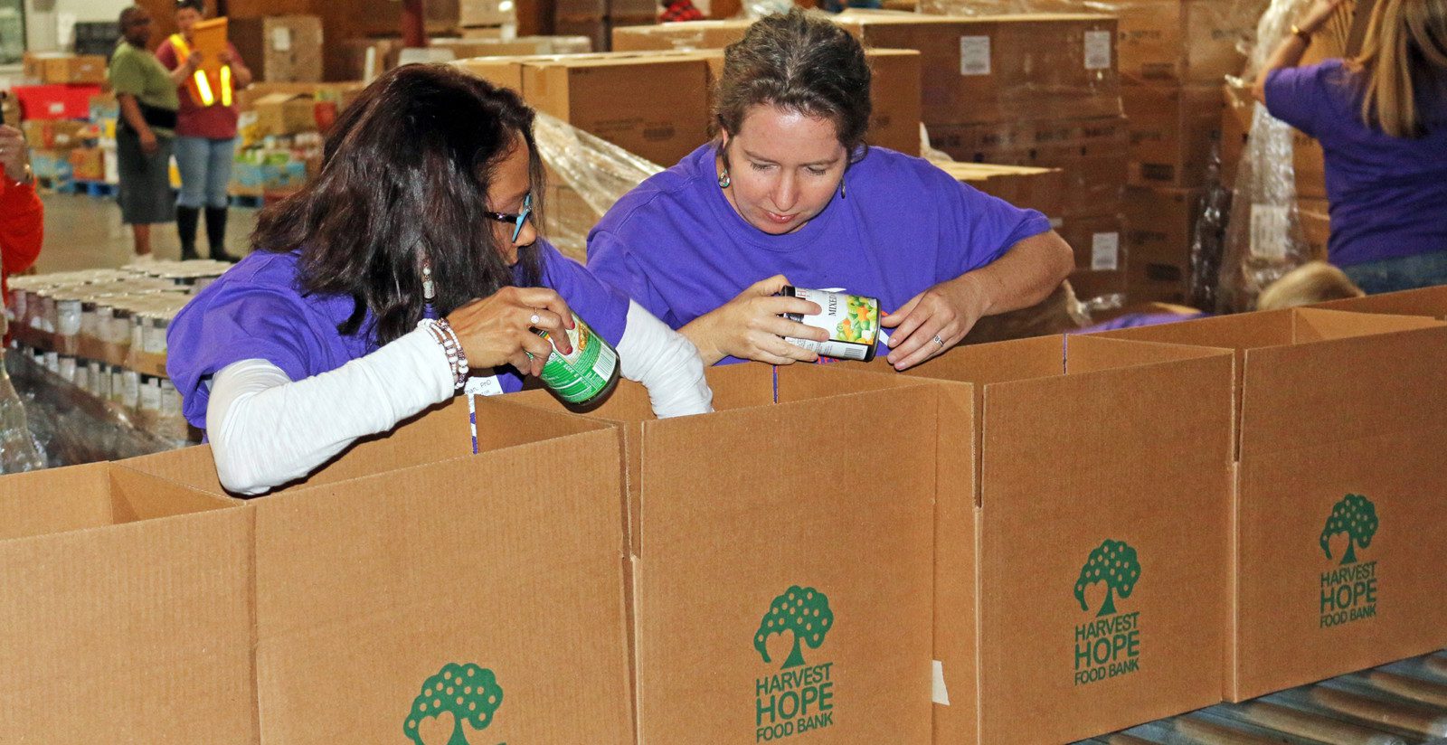 Tarana Khan and Kim Morganello load boxes at Harvest Hope Food Pantry.