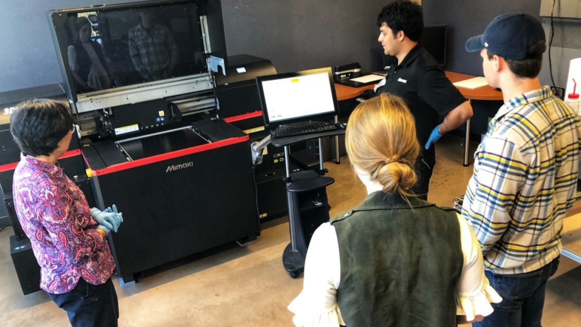 Clemson faculty gather around the 3D printer for training
