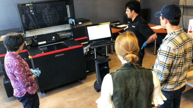 Clemson faculty gather around the 3D printer for training