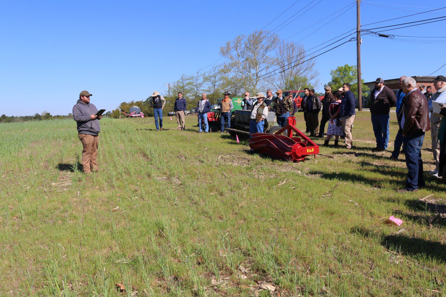 Cody Bishop, farm manager for Clemson's Sandhill REC, explains cover crop mixes that are being grown in the sandy soil of fields at the Center.