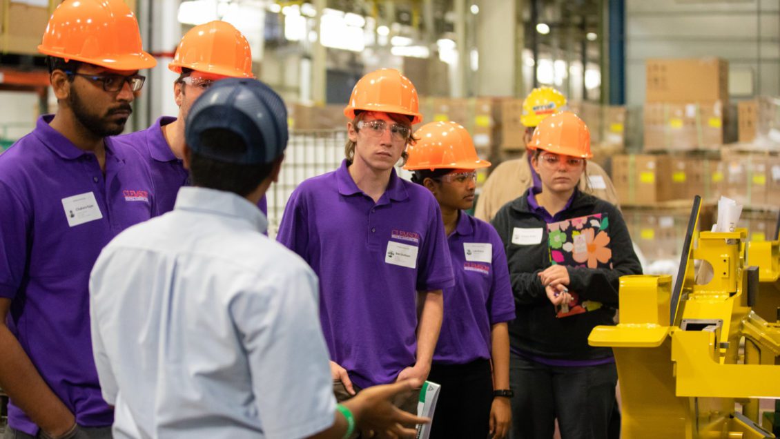 Ben Snelson, center, developed an eye for energy efficiency by touring several manufacturing plants.