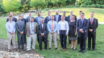 Eighteen graduating student veterans from May 2019 gather outside of Hendrix Student Center.