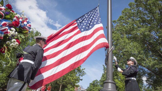 Cadets raise the U.S. flag at the Scroll of Honor Memorial.