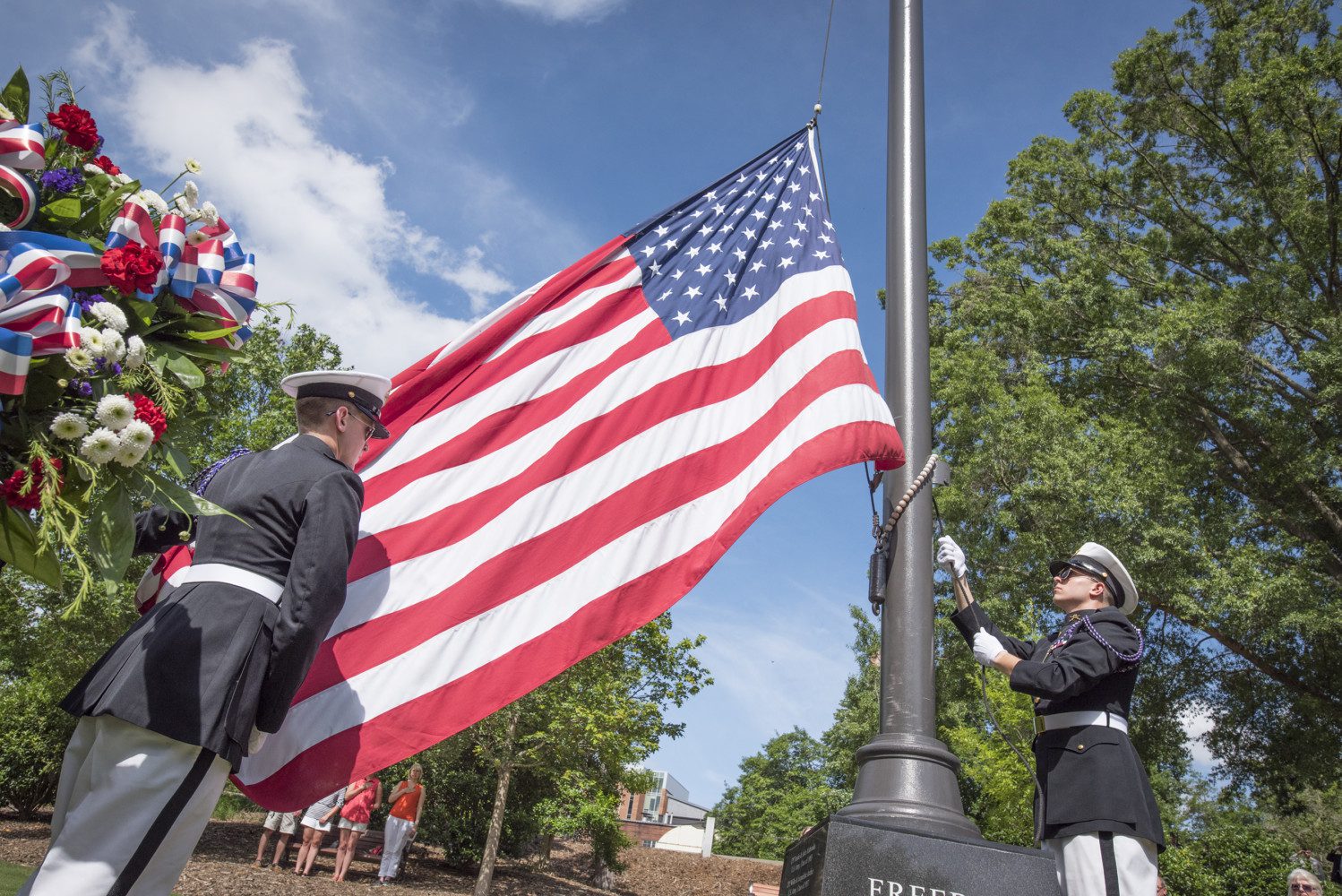 Cadets raise the U.S. flag at the Scroll of Honor Memorial.
