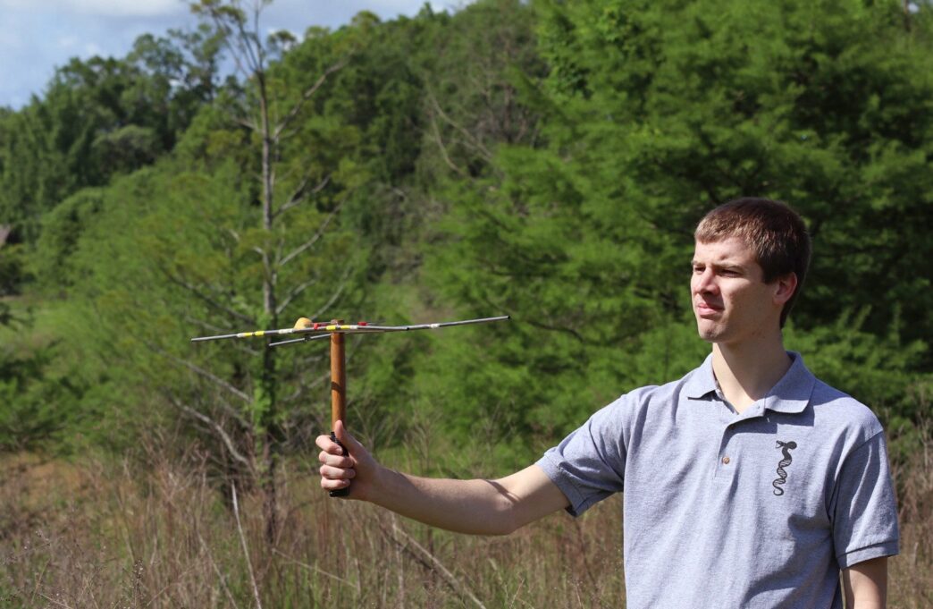 Rhett Rautsaw holds a radio telemetry antenna.