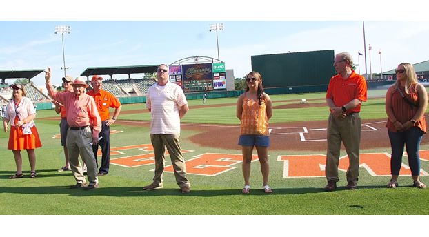 Photo of Lever Hall of Fame inductees and family members being honored at a baseball game