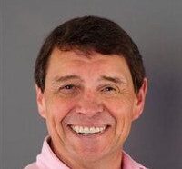 Headshot of Bill Linton, pink polo against gray background