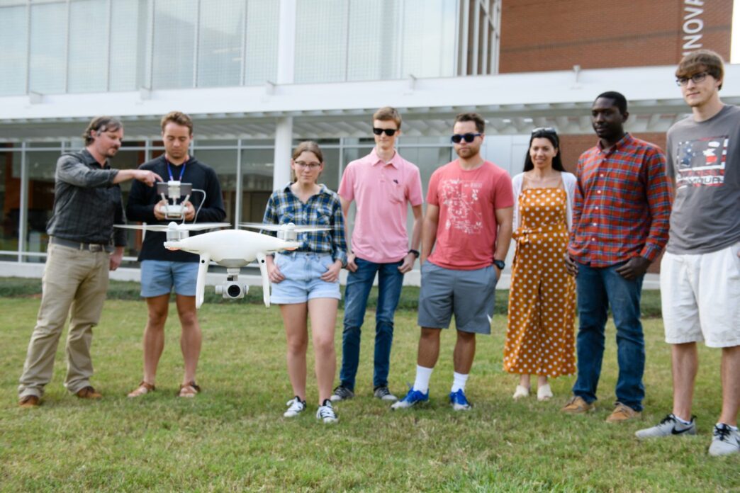 A Clemson instructor showing students and faculty how to pilot a drone